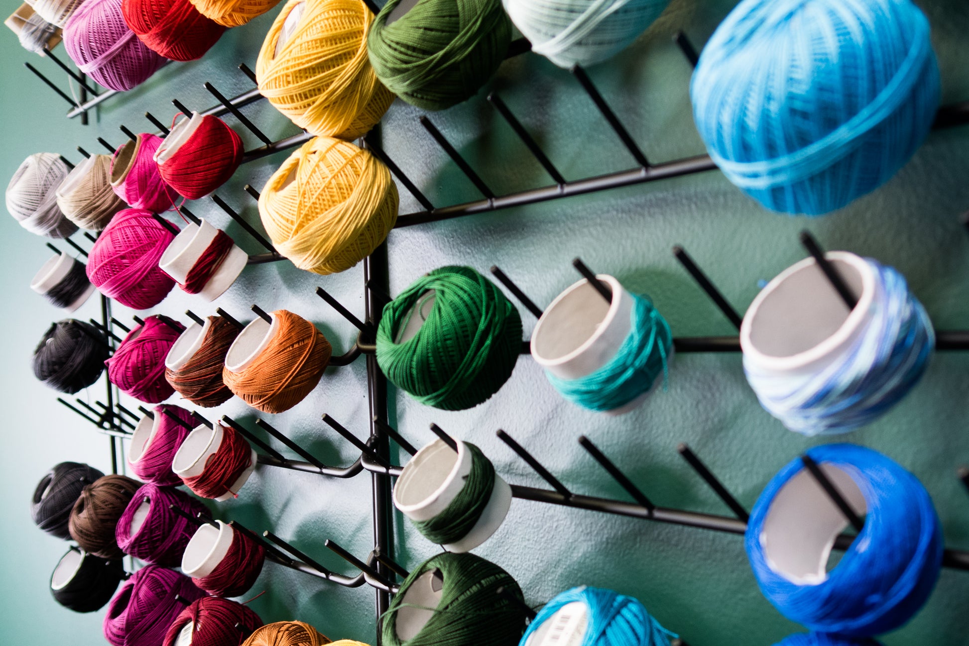 colorful wall of rainbow sorted tatting thread